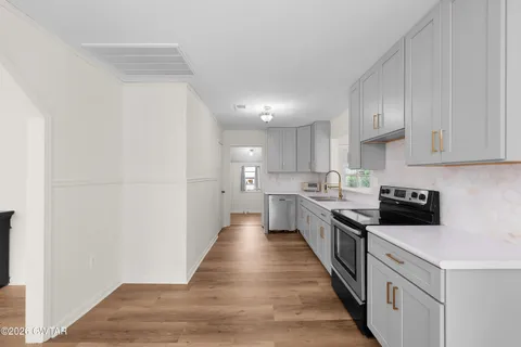 a view of empty room with wooden floor