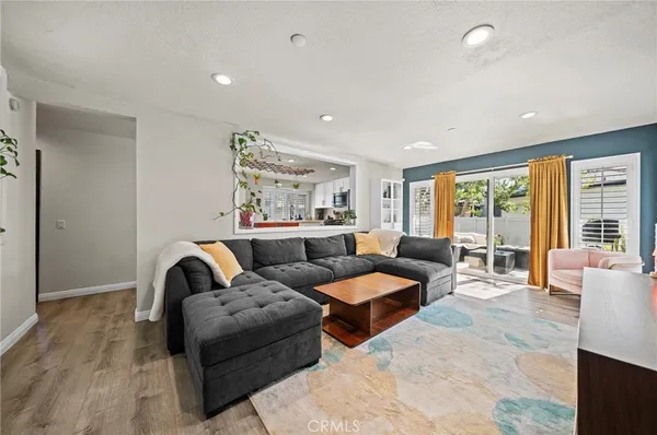 a living room with furniture and large windows