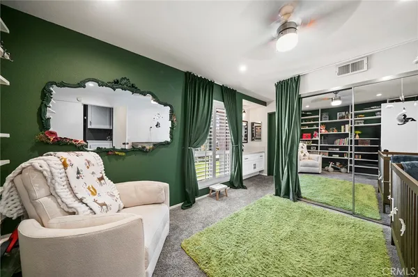 a living room with furniture and a book shelf
