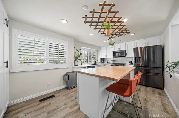 a kitchen with stainless steel appliances granite countertop a refrigerator and a sink