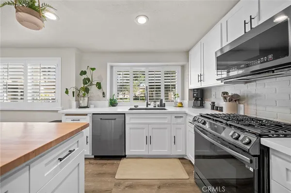 a kitchen with a stove a sink and a microwave