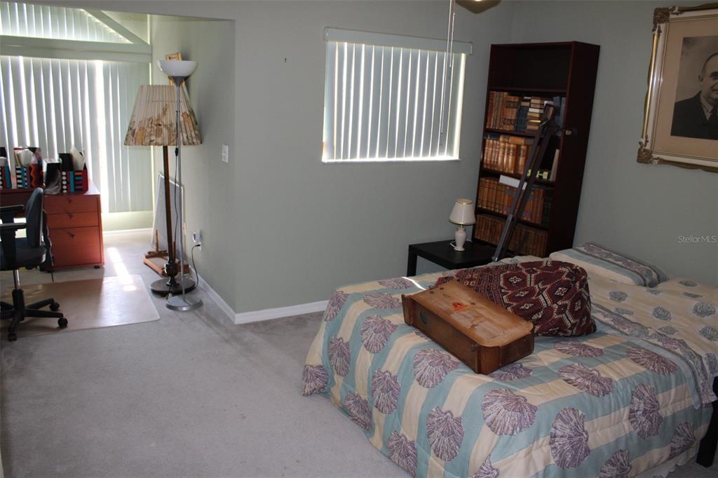 9722 Indian Key Trail, Unit 116 Seminole, FL 33776 - Photo 22 of 65 a bedroom with a bed and a window