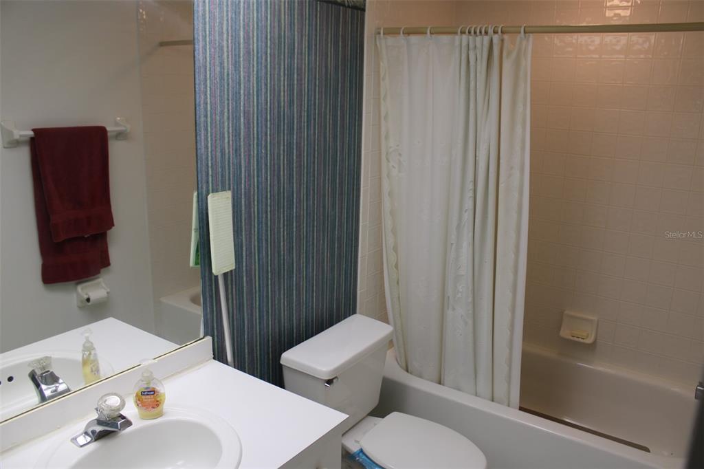 9722 Indian Key Trail, Unit 116 Seminole, FL 33776 - Photo 23 of 65 a bathroom with a sink and a mirror