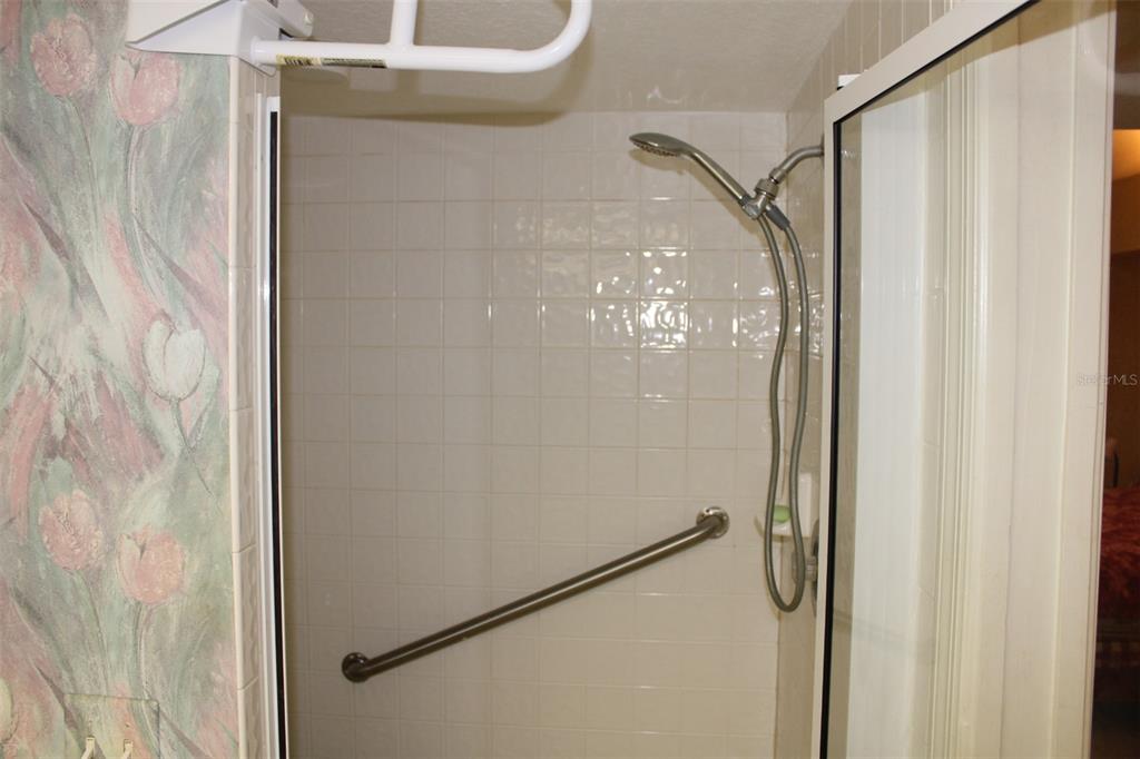 9722 Indian Key Trail, Unit 116 Seminole, FL 33776 - Photo 29 of 65 a bathroom with a glass shower door