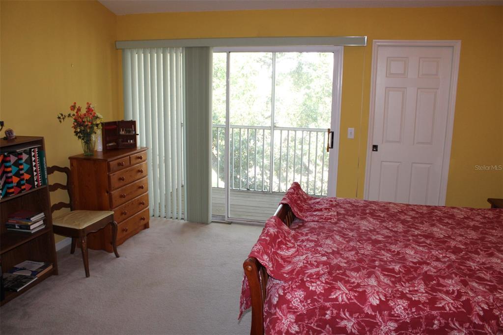9722 Indian Key Trail, Unit 116 Seminole, FL 33776 - Photo 33 of 65 a bed sitting in a bedroom next to a window