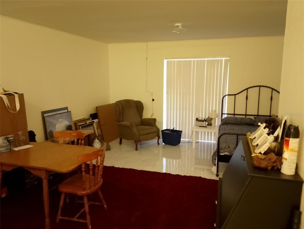 9722 Indian Key Trail, Unit 116 Seminole, FL 33776 - Photo 39 of 65 a view of a workspace with furniture and a couch