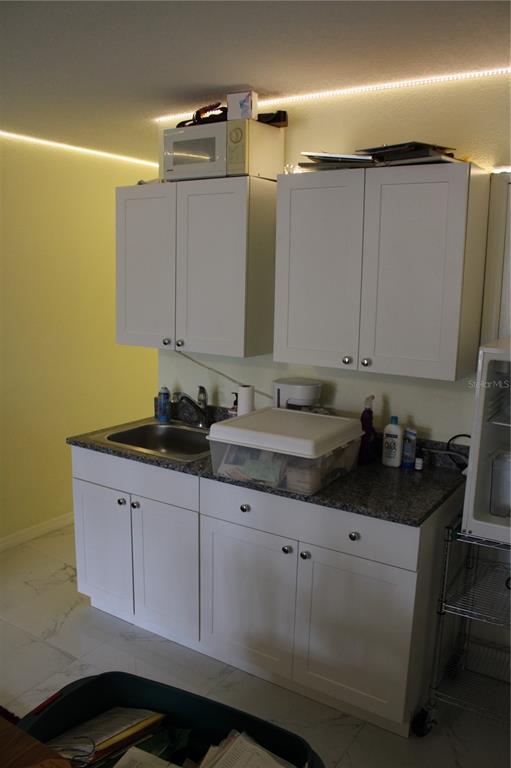 9722 Indian Key Trail, Unit 116 Seminole, FL 33776 - Photo 40 of 65 a bathroom with a sink and a mirror