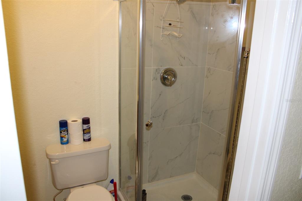 9722 Indian Key Trail, Unit 116 Seminole, FL 33776 - Photo 44 of 65 a white toilet sitting next to a bathroom sink