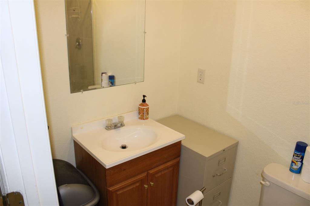 9722 Indian Key Trail, Unit 116 Seminole, FL 33776 - Photo 45 of 65 a bathroom with a sink and a mirror