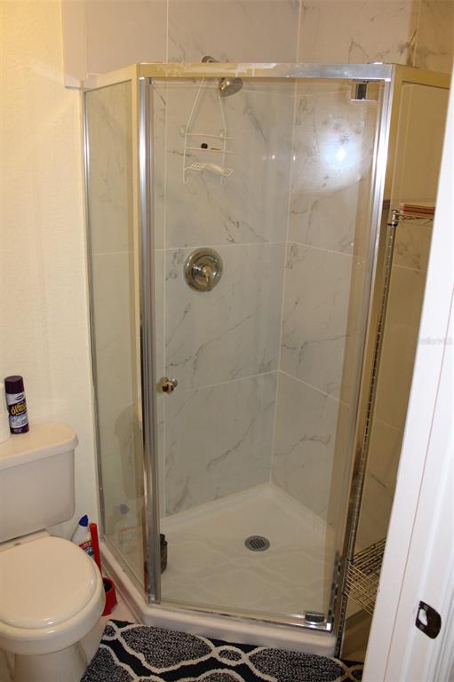 9722 Indian Key Trail, Unit 116 Seminole, FL 33776 - Photo 46 of 65 a bathroom with a shower and a toilet