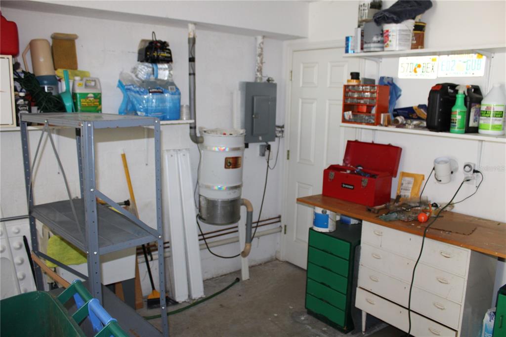9722 Indian Key Trail, Unit 116 Seminole, FL 33776 - Photo 47 of 65 a room with cabinets a washer and dryer