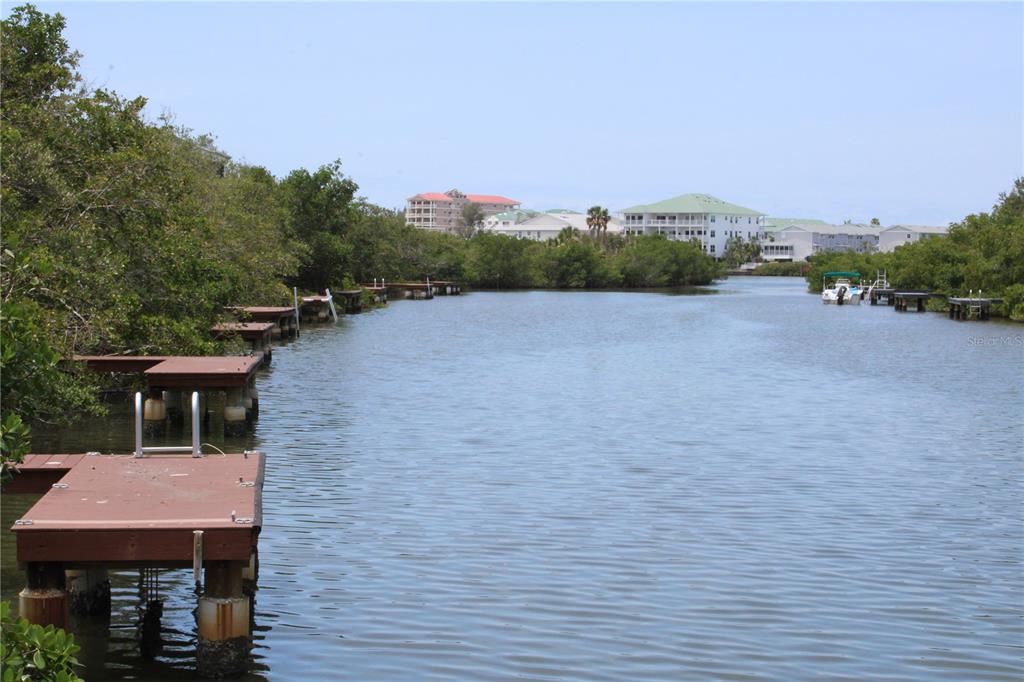 9722 Indian Key Trail, Unit 116 Seminole, FL 33776 - Photo 59 of 65 a aerial view of a house with a yard and lake view