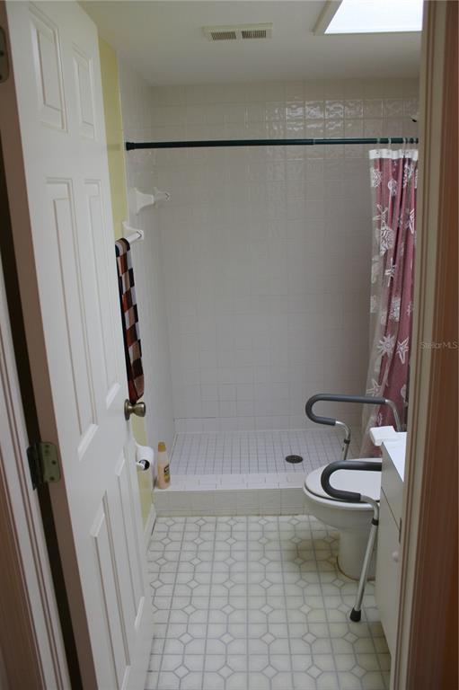 9722 Indian Key Trail, Unit 116 Seminole, FL 33776 - Photo 6 of 65 a bathroom with a granite countertop sink toilet and shower