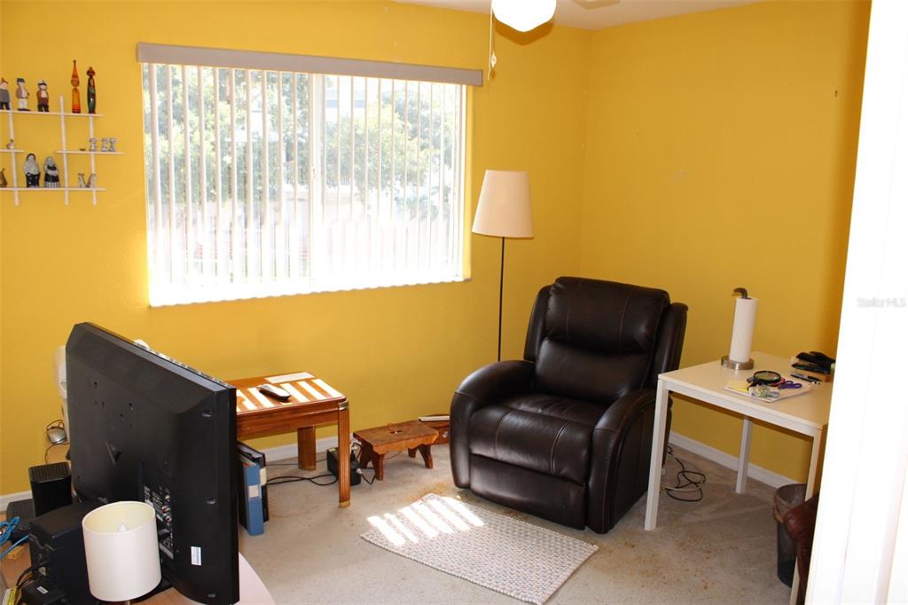 9722 Indian Key Trail, Unit 116 Seminole, FL 33776 - Photo 8 of 65 a living room with furniture and a window