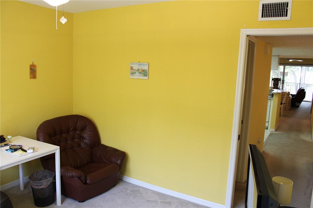 9722 Indian Key Trail, Unit 116 Seminole, FL 33776 - Photo 9 of 65 a living room with a couch and a dining table