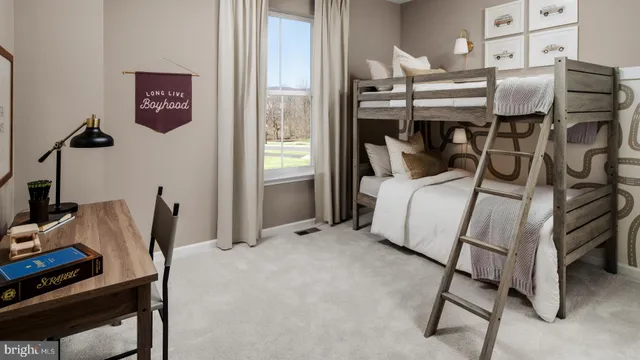 a bedroom with a bed and a desk