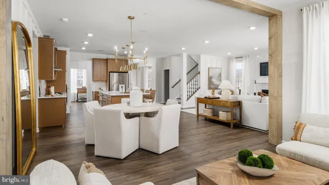 a living room with kitchen island furniture and a view of kitchen