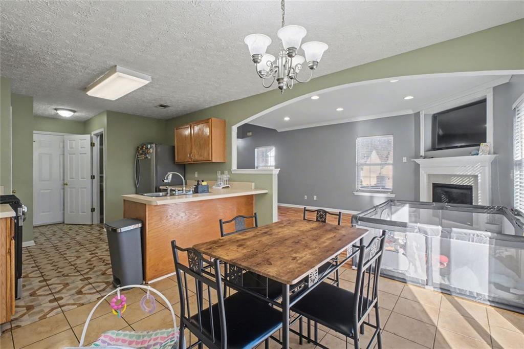 151 Ilex Drive Canton, GA 30114 - Photo 21 of 43 a view of a dining room with furniture and a kitchen