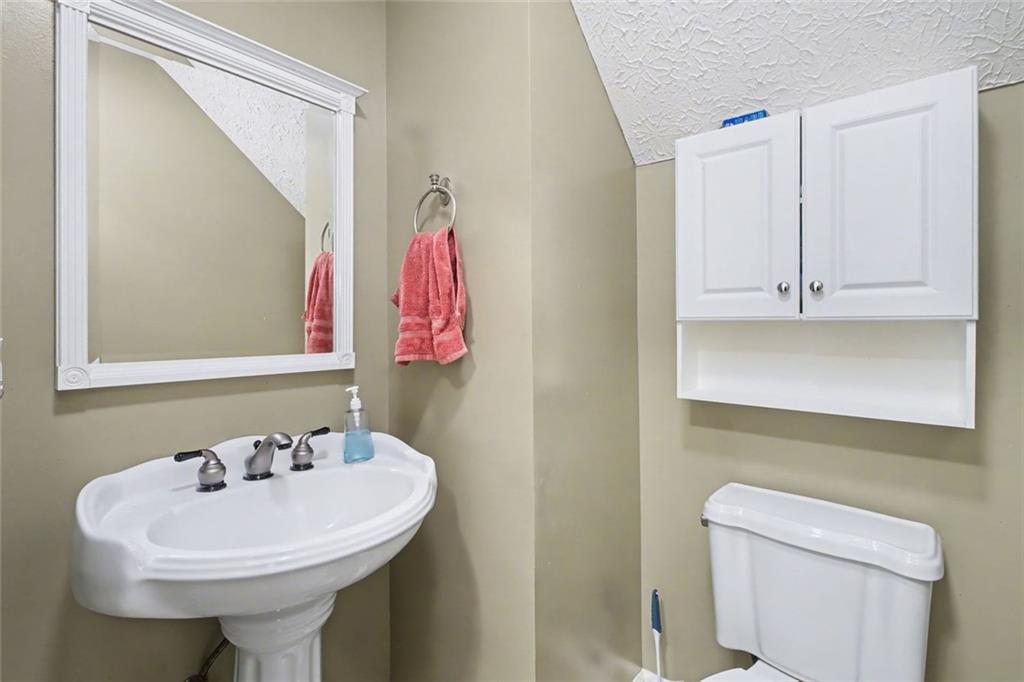 151 Ilex Drive Canton, GA 30114 - Photo 40 of 43 a bathroom with a sink a toilet and a mirror