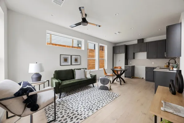 a living room with furniture a flat screen tv and a window