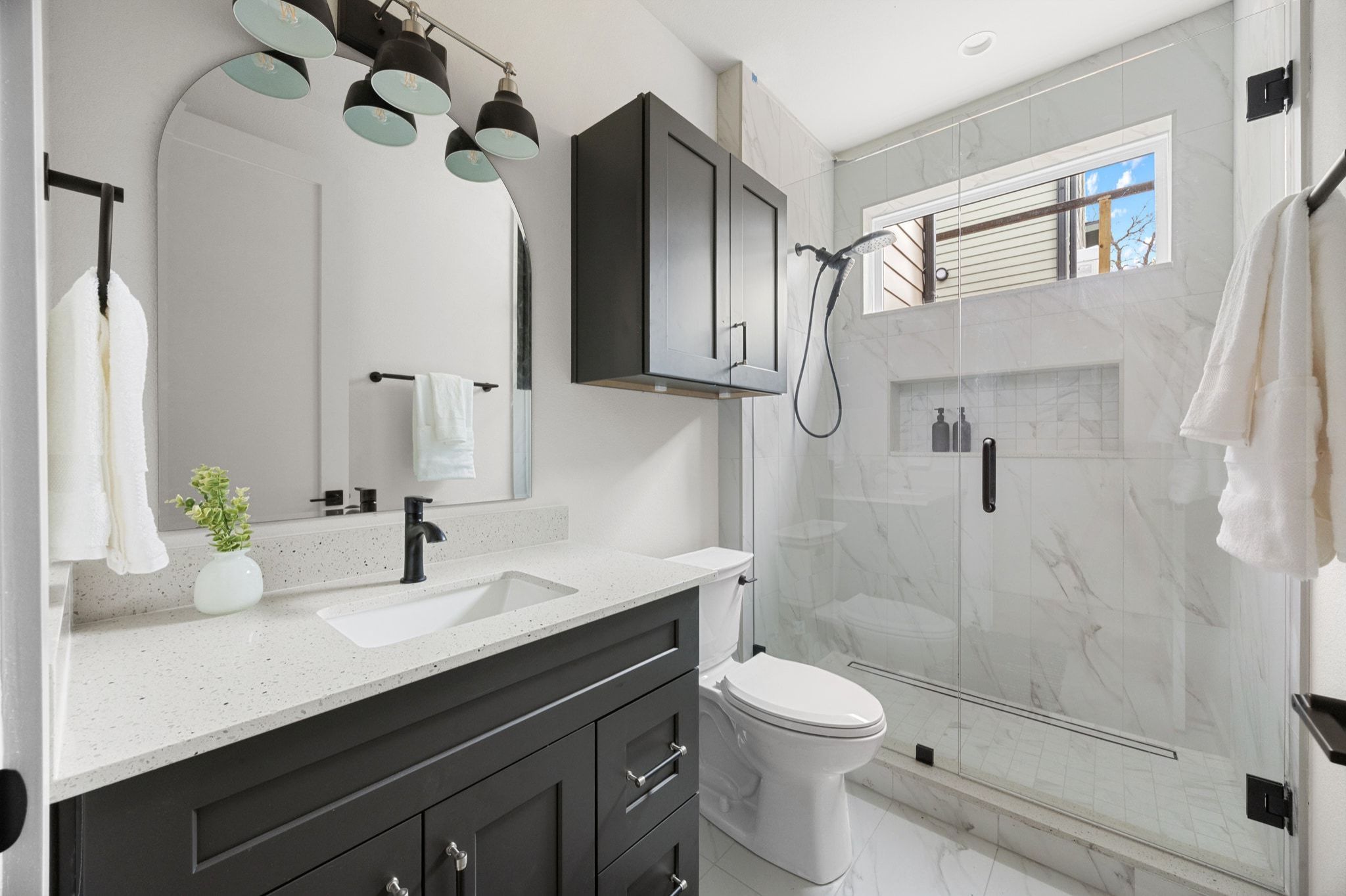 1709 Maple Avenue, Unit 2B Austin, TX 78702 - Photo 13 of 28 a bathroom with a granite countertop sink a toilet and shower