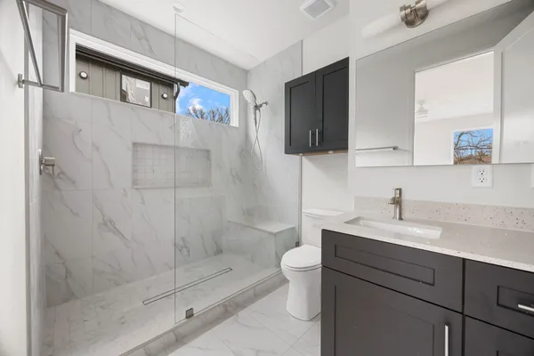 a bathroom with a sink toilet and shower