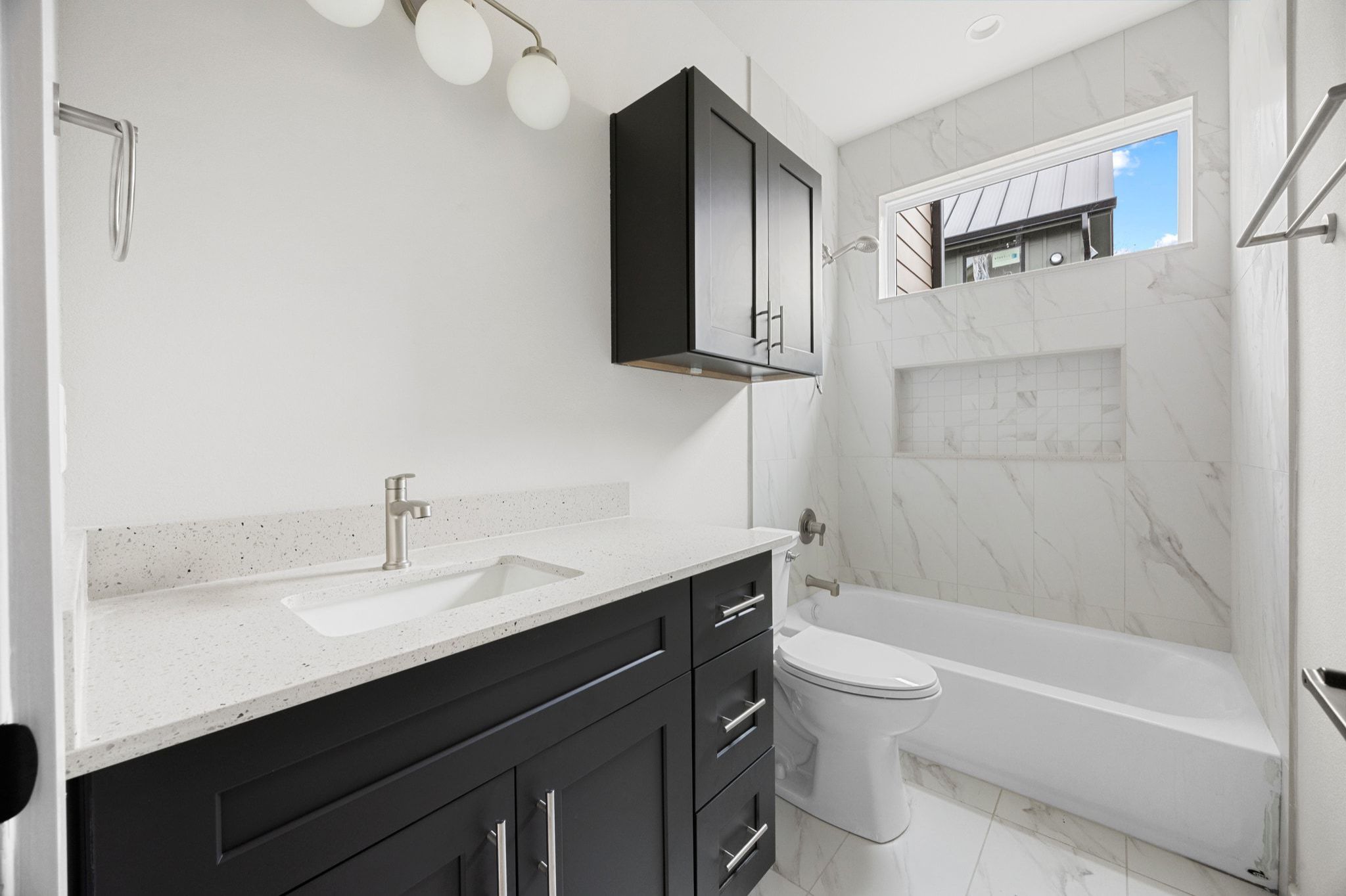 1709 Maple Avenue, Unit 2B Austin, TX 78702 - Photo 25 of 28 a bathroom with a sink a toilet and a bathtub