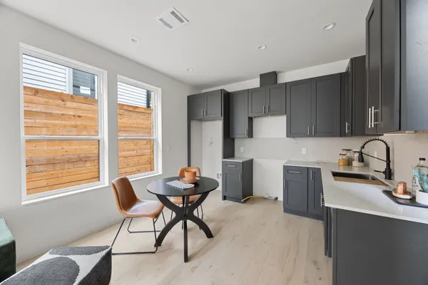 a kitchen with a table chairs and a refrigerator