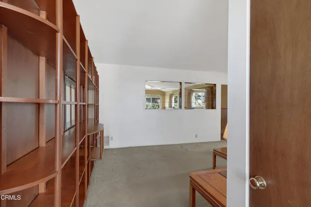 a living room with furniture and a lamp
