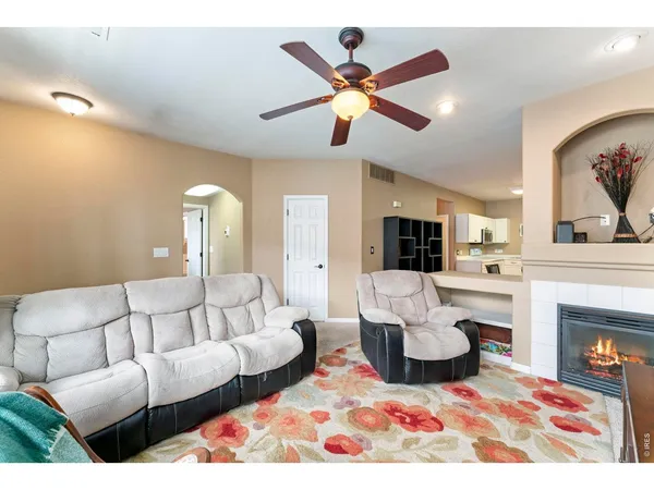 a living room with furniture fireplace and window