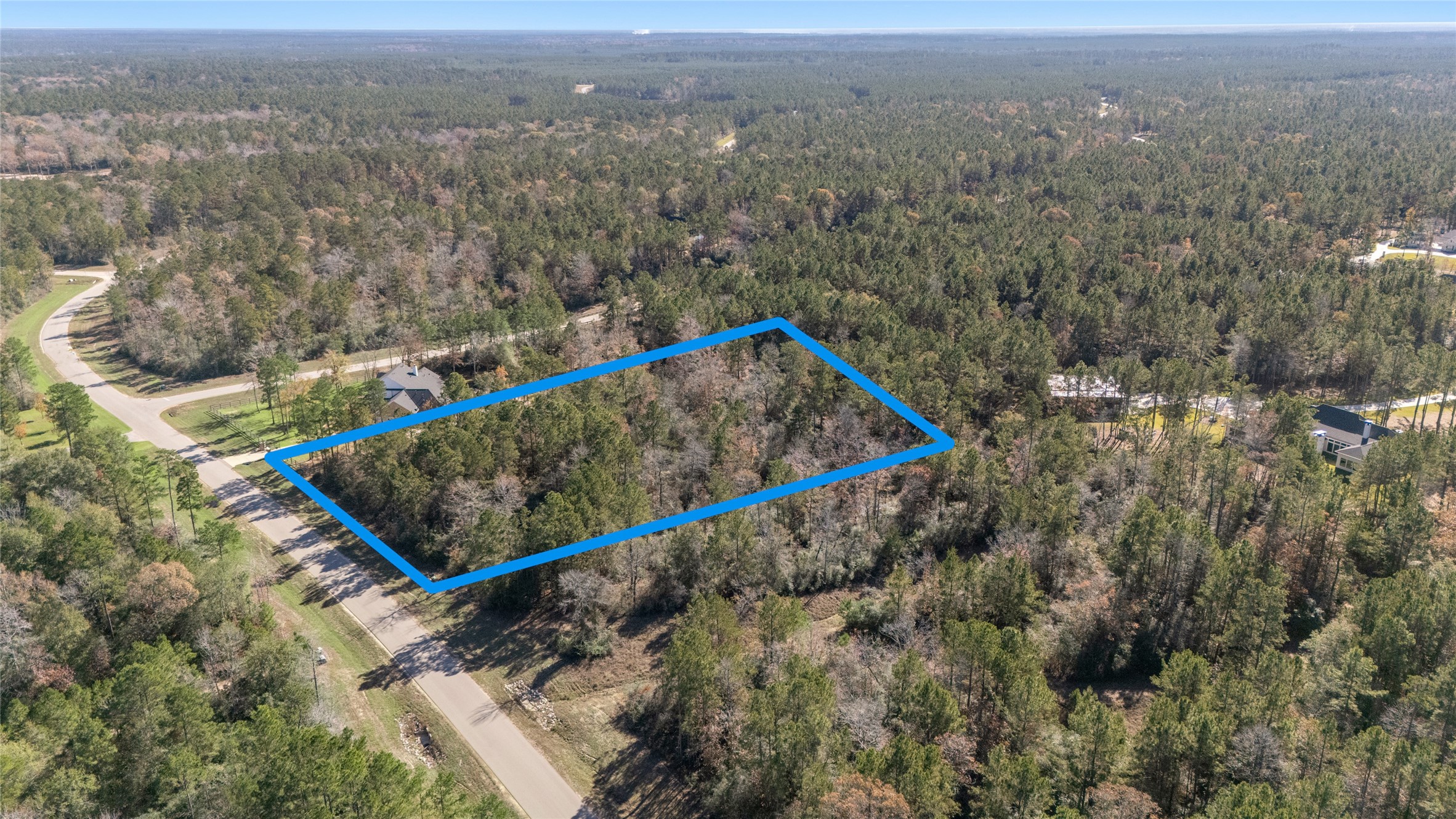 10674 Ruger Road Willis, TX 77378 - Photo 4 of 15 Aerial view highlighting the property boundaries and surrounding natural landscape.