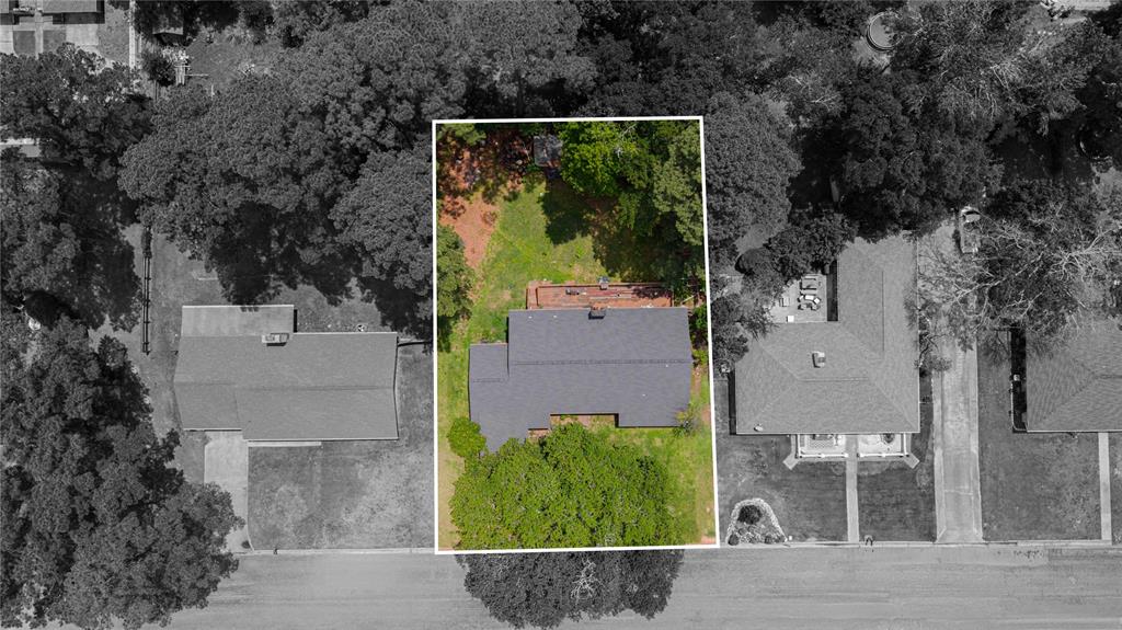 1006 Rikkity Lane Mount Pleasant, TX 75455 - Photo 34 of 39 an aerial view of a house with a yard and large trees