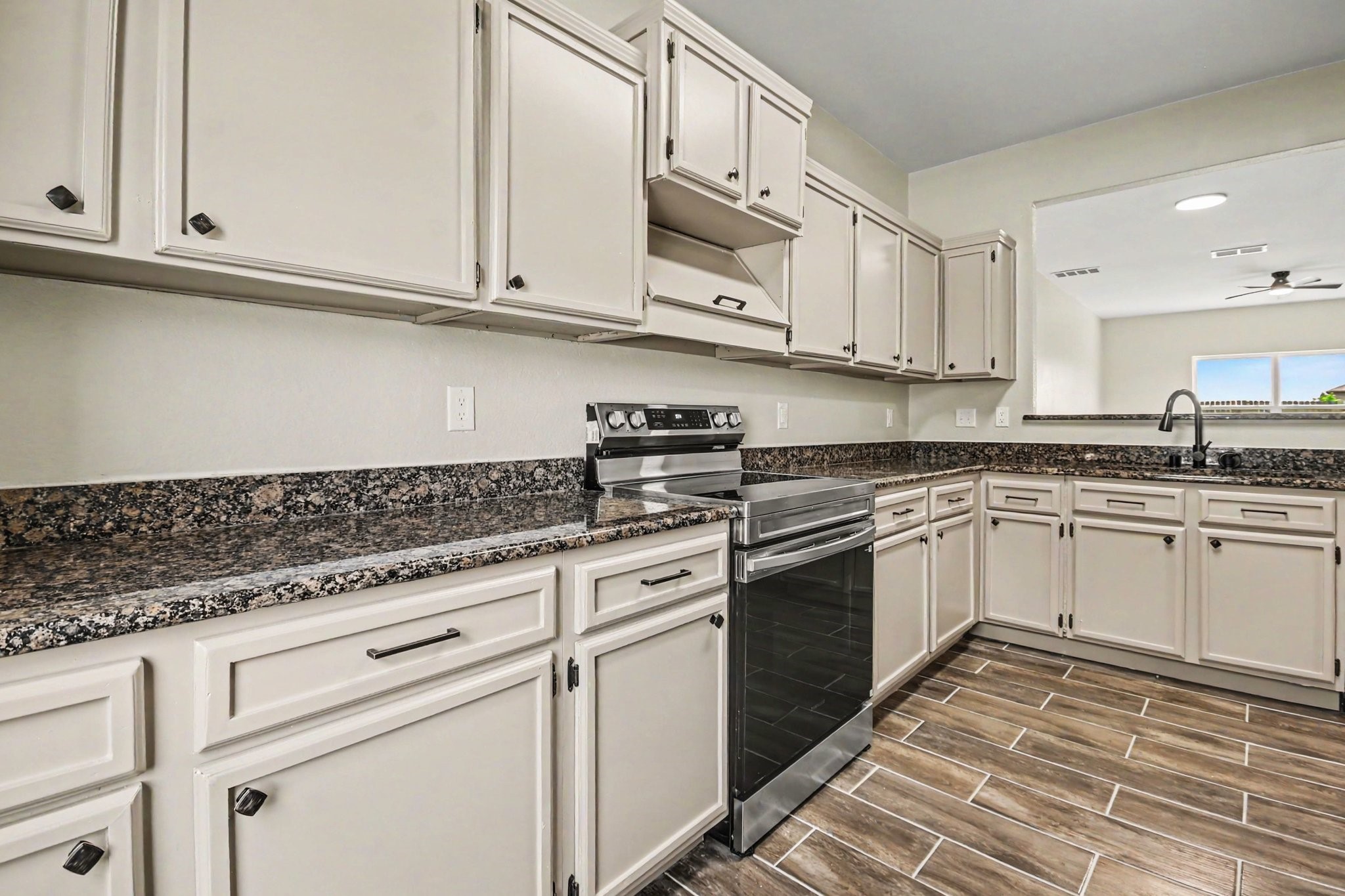 1322 Diamond Drape Drive Rosharon, TX 77583 - Photo 14 of 45 a kitchen with granite countertop white cabinets and white appliances