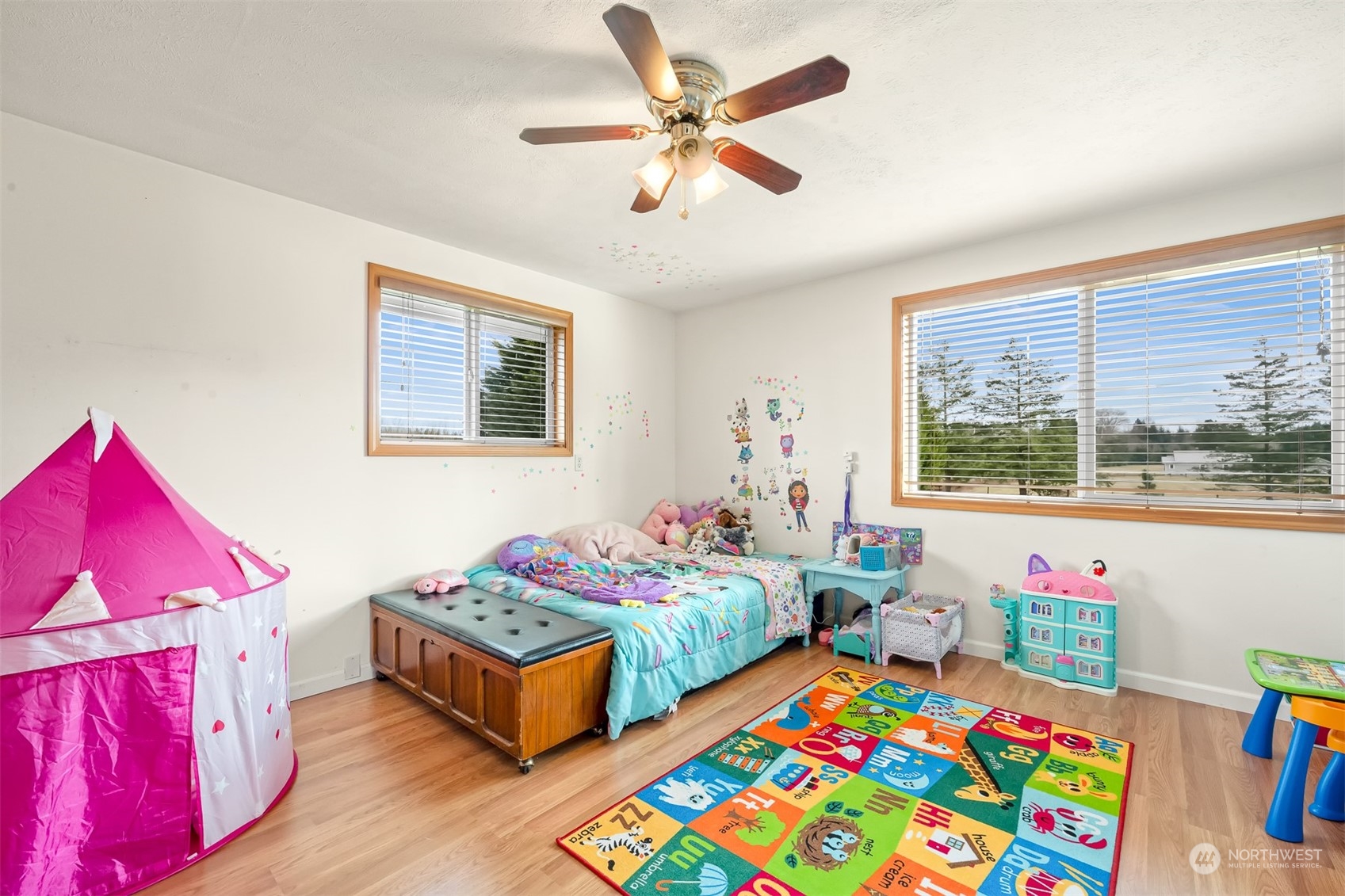 3941 Loomis Trail Road Blaine, WA 98230 - Photo 18 of 40 a bedroom with two beds and a chandelier