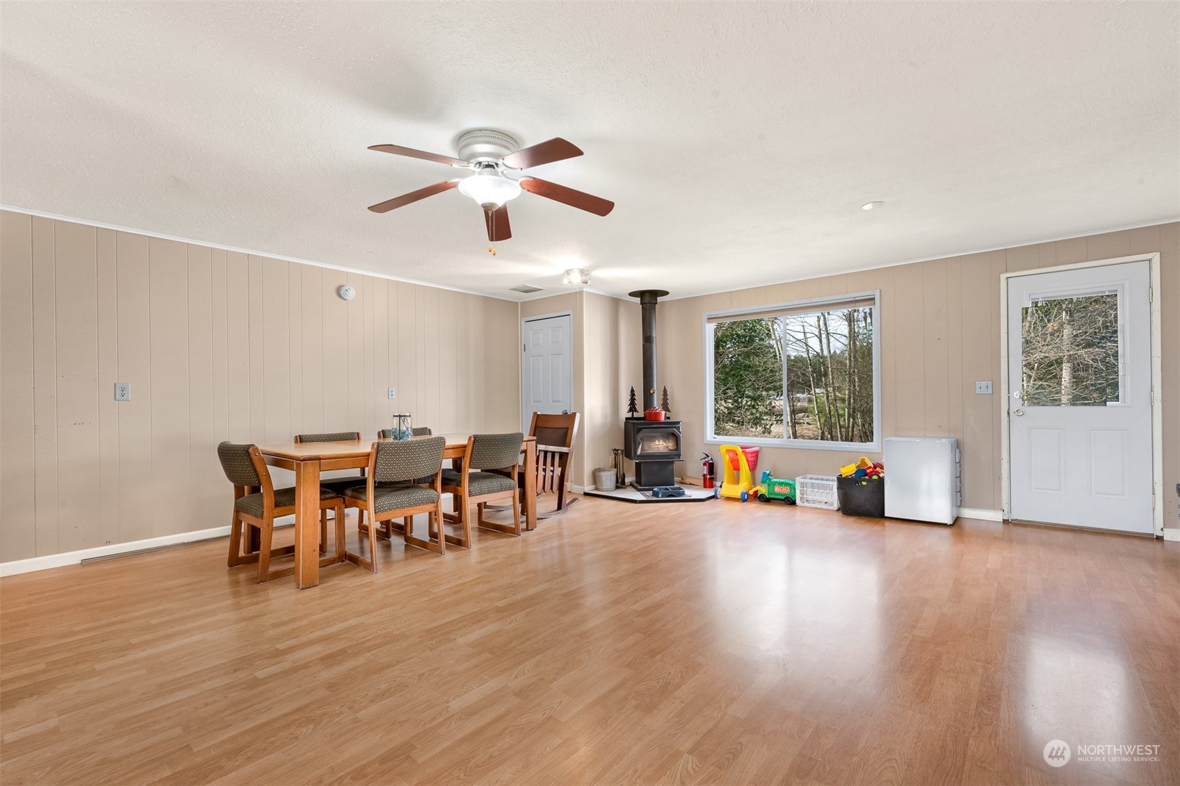 3941 Loomis Trail Road Blaine, WA 98230 - Photo 22 of 40 a view of a livingroom with furniture a ceiling fan and wooden floor