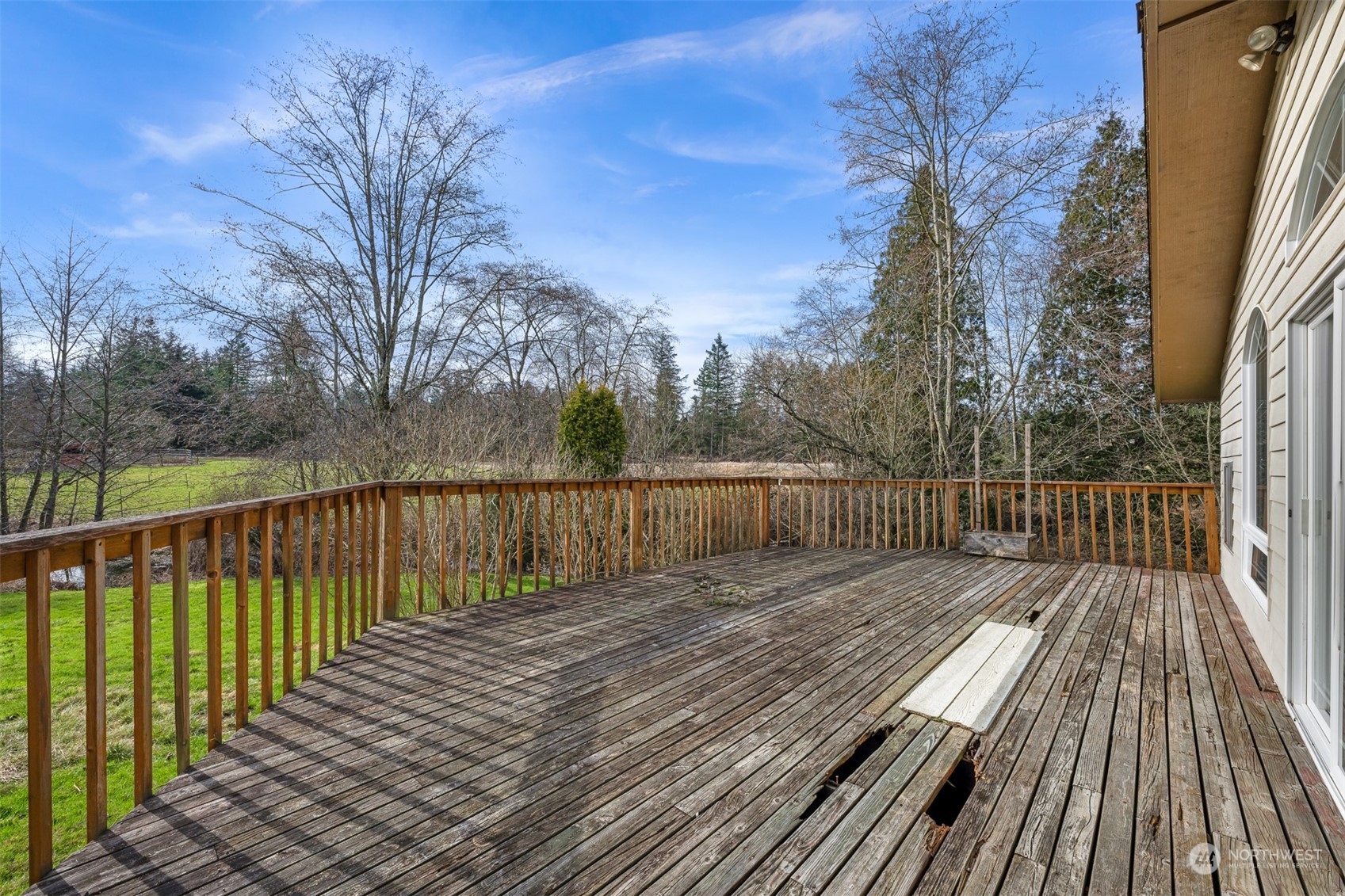 3941 Loomis Trail Road Blaine, WA 98230 - Photo 29 of 40 a balcony with wooden floor and trees