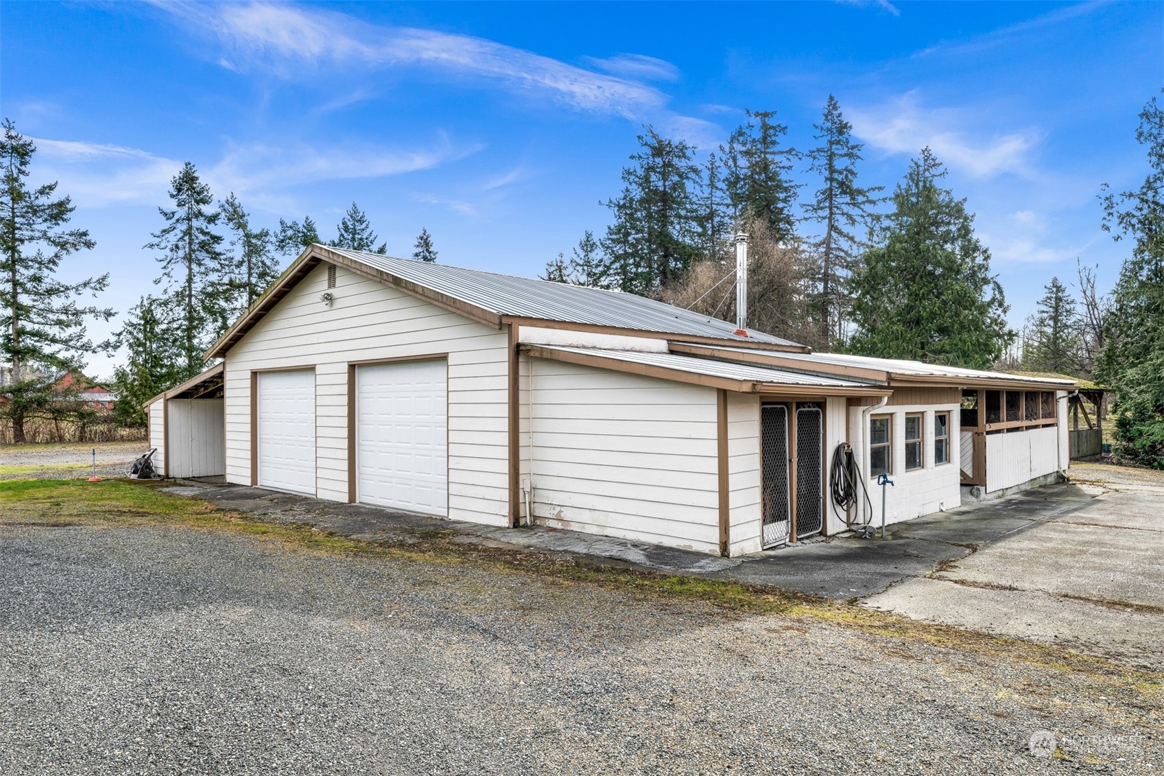 3941 Loomis Trail Road Blaine, WA 98230 - Photo 31 of 40 a view of a white house with a yard and large tree