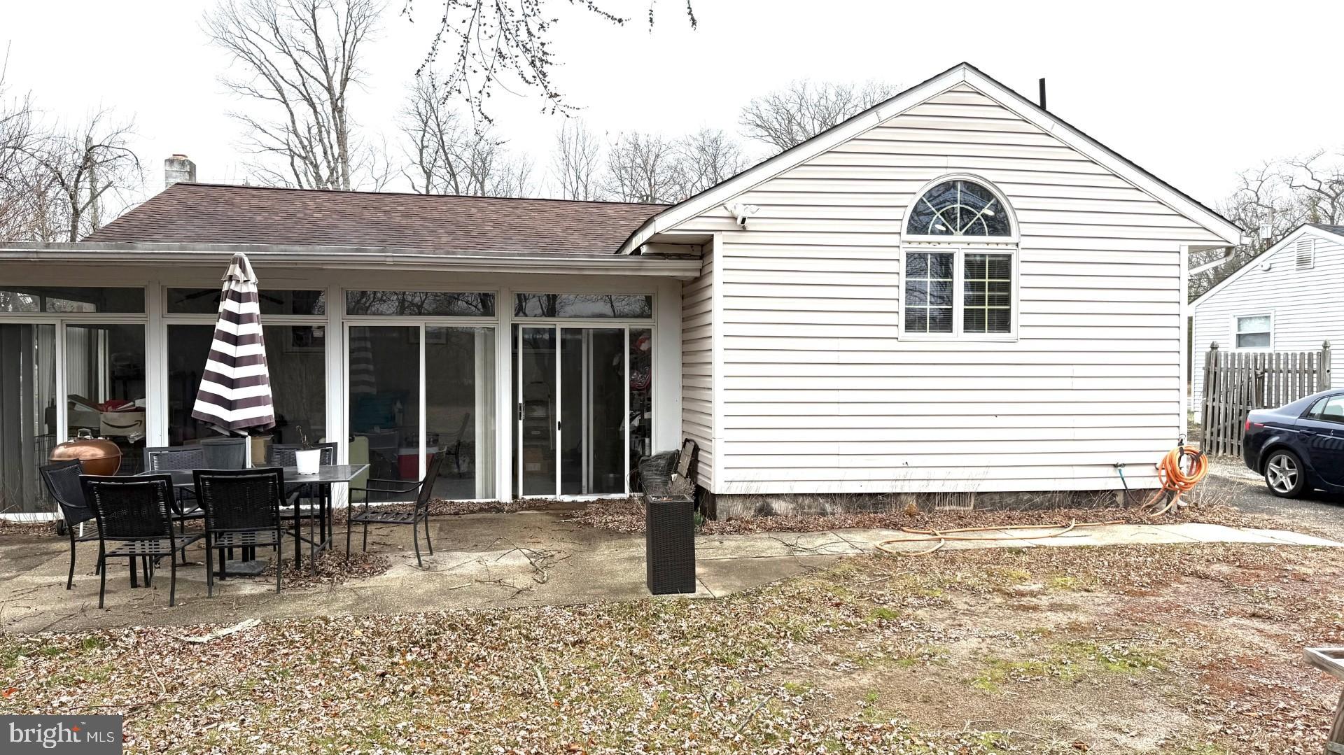 654 Buckshutem Road Bridgeton, NJ 08302 - Photo 14 of 14 a view of a house with a patio and a yard