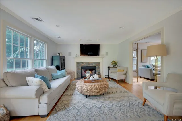 a living room with furniture a fireplace and a flat screen tv