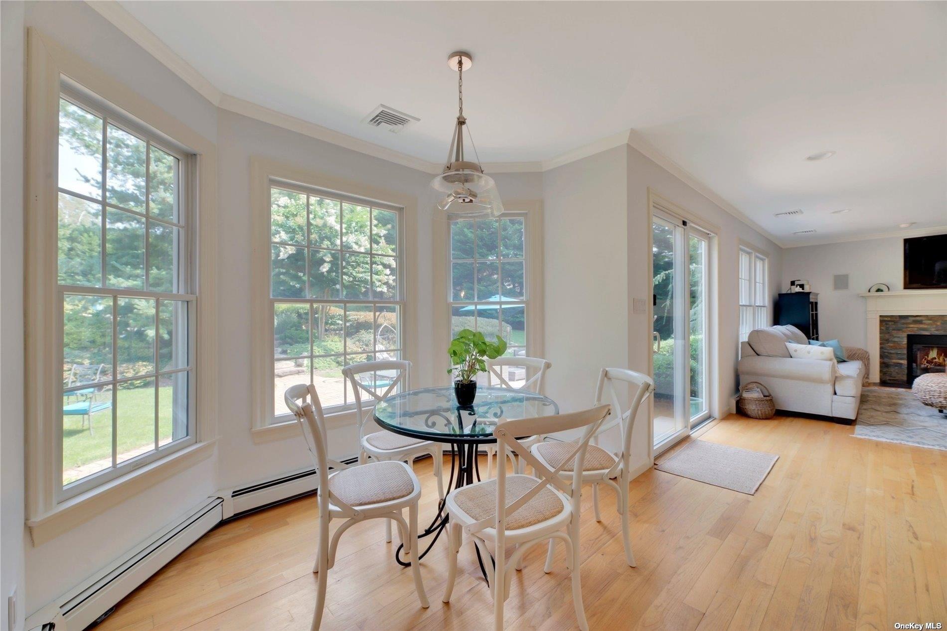 1460 Hillcrest Drive Orient, NY 11957 - Photo 17 of 37 a living room with furniture a table and a chandelier