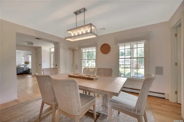 a view of a dining room with furniture wooden floor and chandelier