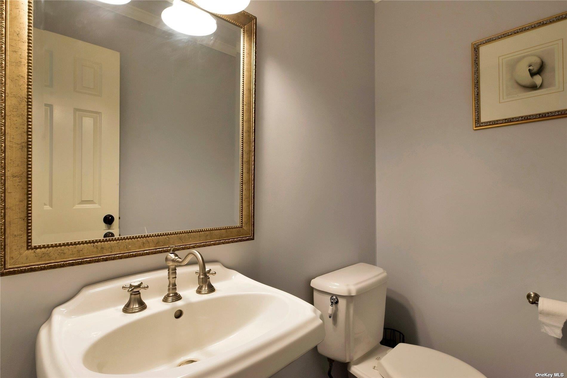 1460 Hillcrest Drive Orient, NY 11957 - Photo 19 of 37 a bathroom with a sink mirror and toilet