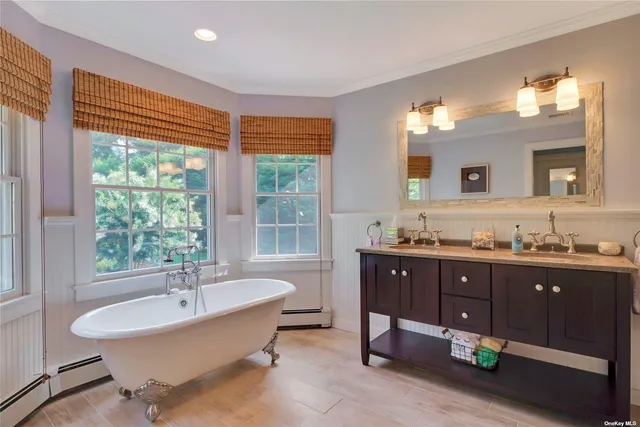 a spacious bathroom with a granite countertop sink and a bathtub