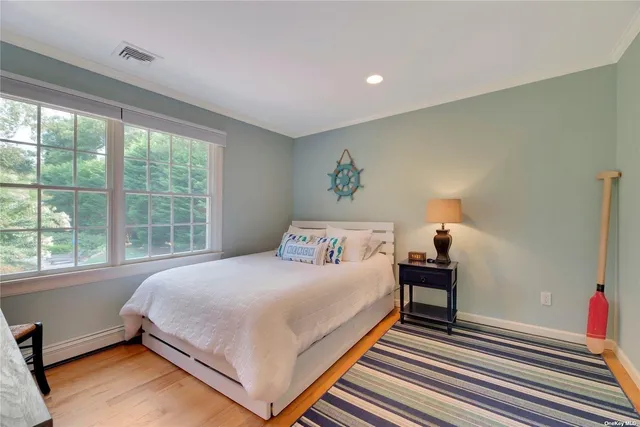 a bedroom with a bed and a large window