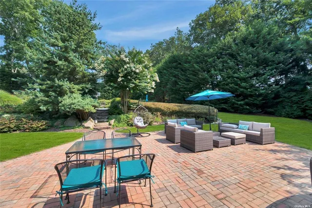 an outdoor sitting area with a garden view