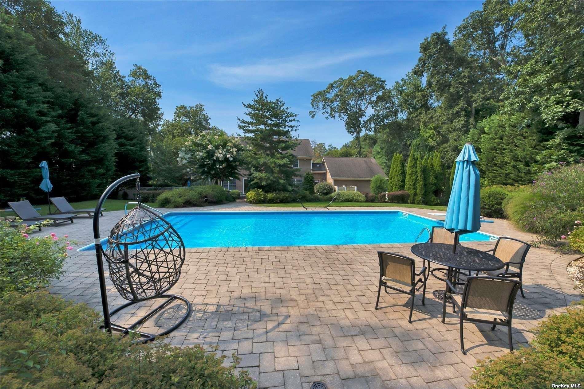 1460 Hillcrest Drive Orient, NY 11957 - Photo 36 of 37 a patio with a table and chairs and potted plants