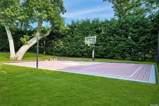 a view of pool with lawn chairs and plants