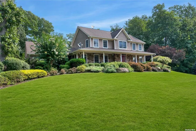 a front view of house with yard and green space