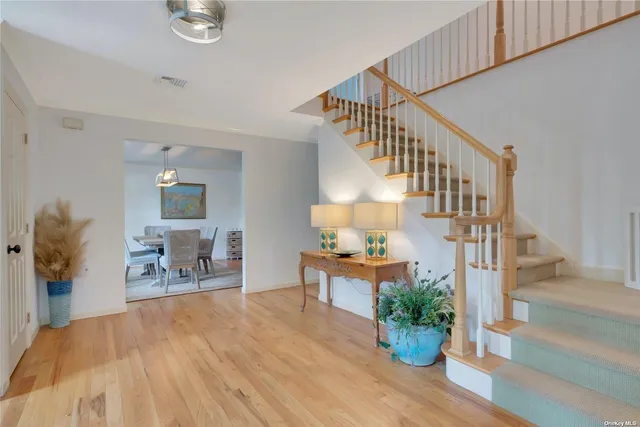 a view of entryway dining room and hall with wooden floor