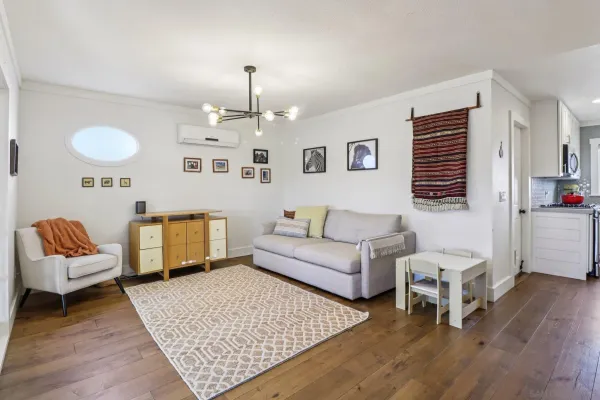 a living room with furniture and wooden floor